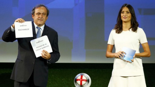 UEFA President Platini shows the name of Bucharest, one of the 13 cities which will host matches at the Euro 2020 tournament to be played across the continent, next to former Miss Switzerland Winiger during a ceremony in Geneva
