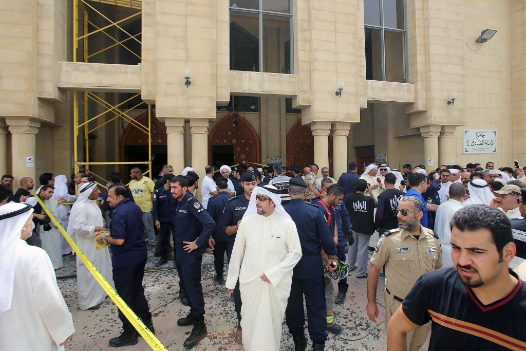 Kuwaiti security forces gather outside the Shiite Al-Imam al-Sadeq mosque after it was targeted by a suicide bombing during Friday prayers on June 26, 2015, in Kuwait City. The Islamic State group-affiliated group in Saudi Arabia, calling itself Najd Province, said militant Abu Suleiman al-Muwahhid carried out the attack, which it claimed was spreading Shiite teachings among Sunni Muslims. AFP PHOTO / YASSER AL-ZAYYAT
